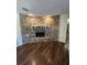 Cozy living room displays hardwood floors, brick fireplace, and ambient lighting creating an inviting atmosphere at 1872 N Akron Dr, Deltona, FL 32738