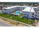 Aerial view of white buildings with pool, parking, and landscaped lawn at 1926 Ocean Shore Blvd # 3120, Ormond Beach, FL 32176