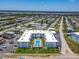 Overhead view of a condo building offering a refreshing pool, green spaces, and ample parking at 1926 Ocean Shore Blvd # 3120, Ormond Beach, FL 32176