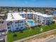 Aerial view of building with community pool, parking and green space at 1926 Ocean Shore Blvd # 3120, Ormond Beach, FL 32176