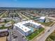 Aerial view showcases a condo building with a refreshing pool, green space, and ample parking at 1926 Ocean Shore Blvd # 3120, Ormond Beach, FL 32176
