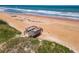 Sandy beach access with wooden stairs, dunes and ocean waves at 1926 Ocean Shore Blvd # 3120, Ormond Beach, FL 32176
