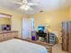 Bedroom with large dresser, desk, and ceiling fan at 1926 Ocean Shore Blvd # 3120, Ormond Beach, FL 32176