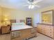 Cozy bedroom with ceiling fan, dresser, and nightstand at 1926 Ocean Shore Blvd # 3120, Ormond Beach, FL 32176
