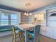 Charming dining room with ocean views, built-in cabinets, and seating for four at 1926 Ocean Shore Blvd # 3120, Ormond Beach, FL 32176