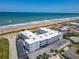 View of the condo building with beach proximity, on-site parking, and lush landscaping at 1926 Ocean Shore Blvd # 3120, Ormond Beach, FL 32176