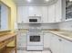 Bright kitchen with white appliances and ample counter space at 1926 Ocean Shore Blvd # 3120, Ormond Beach, FL 32176
