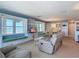 Bright living room features built-in shelves, window seating with ocean views, and comfortable furniture at 1926 Ocean Shore Blvd # 3120, Ormond Beach, FL 32176
