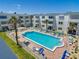 Aerial view of the community pool area, surrounded by lounge chairs and well-manicured landscaping at 1926 Ocean Shore Blvd # 3120, Ormond Beach, FL 32176
