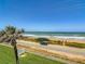 Ocean view showcasing beach access and an idyllic coastal community, with parking and greenery at 1926 Ocean Shore Blvd # 3120, Ormond Beach, FL 32176