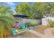 Backyard offers a play area, garden beds, and a shed, creating a functional and enjoyable space at 1994 Excalibur Dr, Orlando, FL 32822