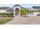 Charming home featuring lush landscaping, a brick driveway, and a covered entryway at 1994 Excalibur Dr, Orlando, FL 32822