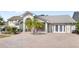 Inviting front view of house with brick driveway and some palm trees at 1994 Excalibur Dr, Orlando, FL 32822