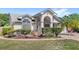 Landscaped front yard view with various decorations and bushes at 1994 Excalibur Dr, Orlando, FL 32822