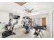 Bright home gym featuring modern exercise equipment, ceiling fan, and natural light from French doors at 1994 Excalibur Dr, Orlando, FL 32822