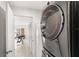 Hallway leading to a home gym, showcased with a modern washer and dryer at 1994 Excalibur Dr, Orlando, FL 32822