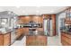 This kitchen offers granite countertops, a stainless steel refrigerator, and custom cabinets at 1994 Excalibur Dr, Orlando, FL 32822