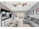 Spacious living room features a ceiling fan, TV, modern furniture, and bright neutral walls at 1994 Excalibur Dr, Orlando, FL 32822