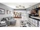 Open living space with ceiling fans, tile floors, and access to kitchen at 1994 Excalibur Dr, Orlando, FL 32822