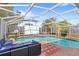 Beautiful screened-in pool area with outdoor seating and entertainment options, great for entertaining at 1994 Excalibur Dr, Orlando, FL 32822