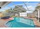 Screened-in pool area with seating and a movie screen for outdoor entertainment, perfect for relaxation at 1994 Excalibur Dr, Orlando, FL 32822