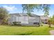 Backyard view of a screened-in pool offering privacy and protection from insects at 1994 Excalibur Dr, Orlando, FL 32822
