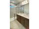 Bathroom featuring a double sink vanity, tiled shower, and modern fixtures at 2013 Stone Wall Ct, Lake Hamilton, FL 33851