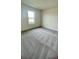 Cozy bedroom with large window and plush carpeting, offering a bright and comfortable space at 2013 Stone Wall Ct, Lake Hamilton, FL 33851