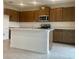 Modern kitchen featuring stainless steel appliances, a kitchen island, and ample cabinet space at 2013 Stone Wall Ct, Lake Hamilton, FL 33851
