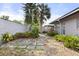 Backyard showcasing a stone pathway and a variety of plants and landscaping at 2138 Whitehall Dr, Winter Park, FL 32792