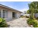 The backyard features a gray-toned home with a concrete-tile patio at 2138 Whitehall Dr, Winter Park, FL 32792