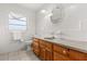 Bathroom with wood vanity, tile floor, and decorative framed mirror at 2138 Whitehall Dr, Winter Park, FL 32792