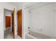 Tiled bathroom showcasing a bathtub, shower, and convenient storage spaces at 2138 Whitehall Dr, Winter Park, FL 32792
