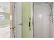 Bathroom features a shower with accessibility handrail and access to primary bedroom at 2138 Whitehall Dr, Winter Park, FL 32792