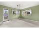 Green-walled bedroom with a ceiling fan, carpeted floor, and door leading to the exterior at 2138 Whitehall Dr, Winter Park, FL 32792