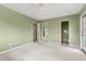 Green-walled bedroom featuring carpeted floor, a ceiling fan, and three doors at 2138 Whitehall Dr, Winter Park, FL 32792