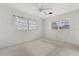 Bright, empty bedroom with carpeted floor, a ceiling fan, and two windows at 2138 Whitehall Dr, Winter Park, FL 32792