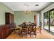 Dining room with wooden furniture, light green walls, and sliding glass doors at 2138 Whitehall Dr, Winter Park, FL 32792