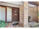 Close up of the front door with brick columns and a tiled entryway at 2138 Whitehall Dr, Winter Park, FL 32792