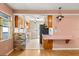 Charming kitchen featuring a breakfast bar, pink countertops and classic wooden cabinetry at 2138 Whitehall Dr, Winter Park, FL 32792