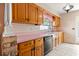 Classic kitchen with wood cabinetry, bright countertops, and charming wallpaper at 2138 Whitehall Dr, Winter Park, FL 32792
