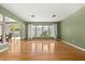 Spacious living area with hardwood floors, large windows, and seamless access to adjacent rooms at 2138 Whitehall Dr, Winter Park, FL 32792