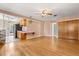 Open-concept living and dining room with hardwood floors and pink accent walls at 2138 Whitehall Dr, Winter Park, FL 32792