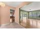 Open-concept living room with hardwood floors and natural light from large windows at 2138 Whitehall Dr, Winter Park, FL 32792