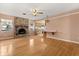 Cozy living room boasts a brick fireplace, hardwood floors, and a kitchen bar area with seating at 2138 Whitehall Dr, Winter Park, FL 32792