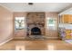 Living room with a brick fireplace, wood floors, adjacent kitchen with breakfast bar at 2138 Whitehall Dr, Winter Park, FL 32792