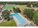 Aerial view of a large swimming pool area with lush greenery and various recreational amenities at 2138 Whitehall Dr, Winter Park, FL 32792
