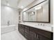 Spa-like bathroom featuring a soaking tub, double vanity, and elegant marble finishes at 220 S Summerlin Ave, Orlando, FL 32801