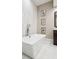 Stylish bathroom featuring a freestanding tub, marble tile, and contemporary fixtures at 220 S Summerlin Ave, Orlando, FL 32801