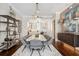 Beautiful dining area with a marble table, stylish shelving, and an open view to the kitchen at 220 S Summerlin Ave, Orlando, FL 32801